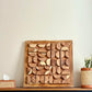 Wooden wall art piece on wall in living room 