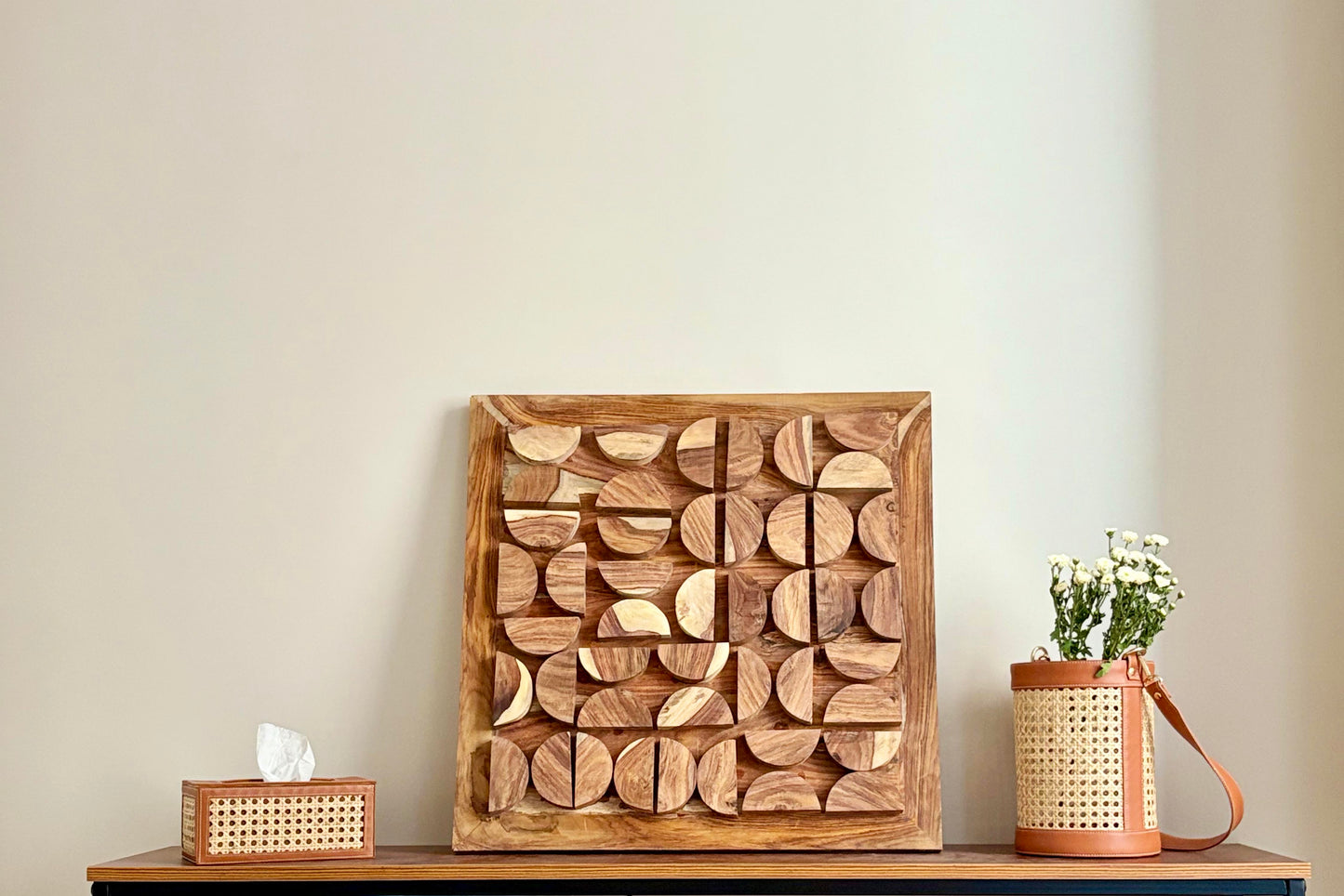 Wooden wall art piece on wall in living room 