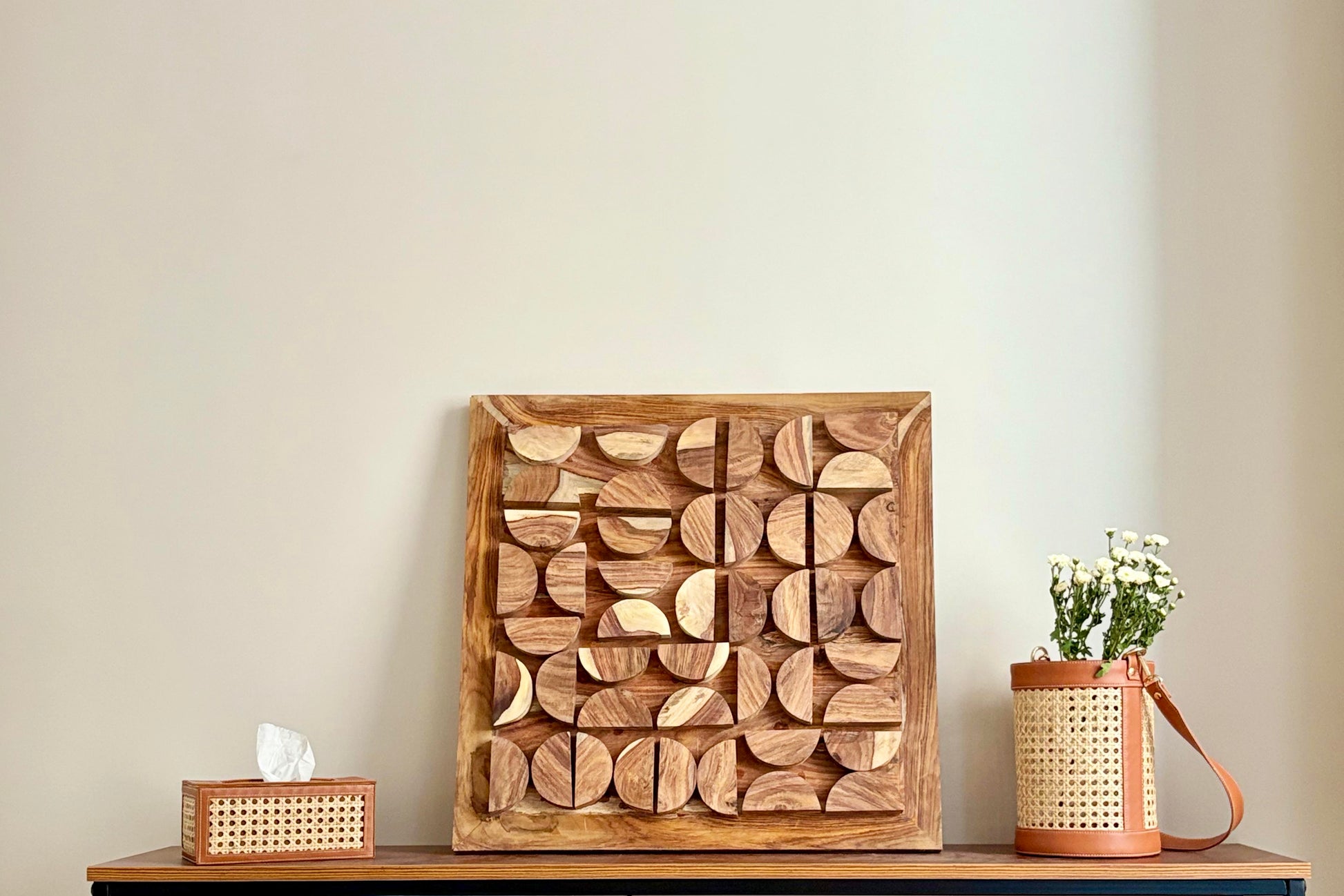 Wooden wall art piece on wall in living room 