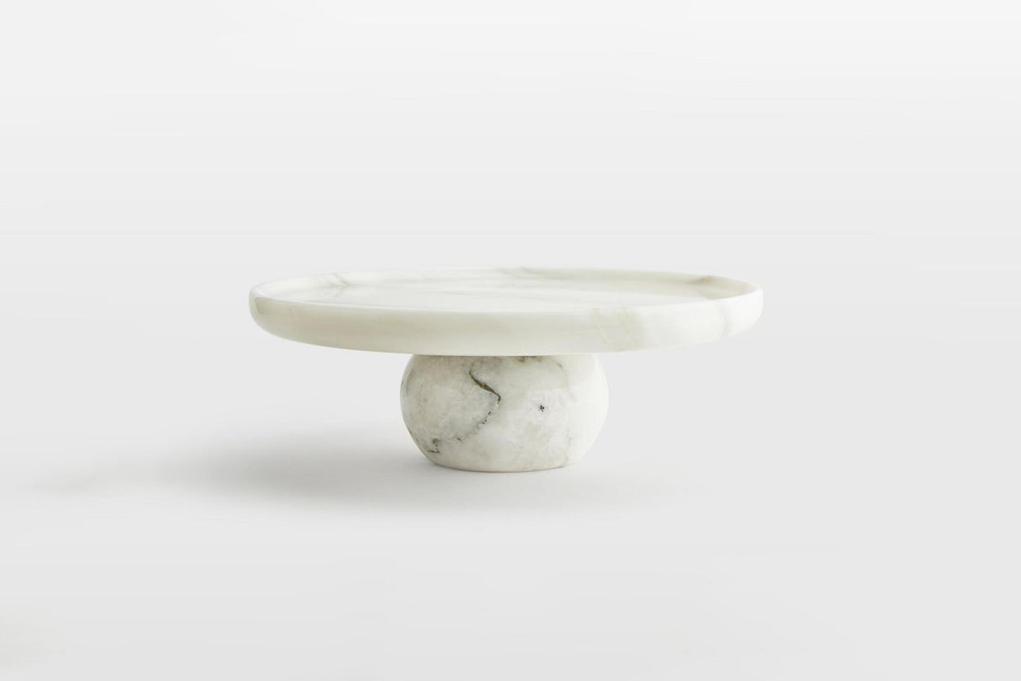 Marble-patterned marble cake stand   on a white background